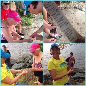 Crew teach children how to hunt for treasure buried ashore using the yacht's GPS